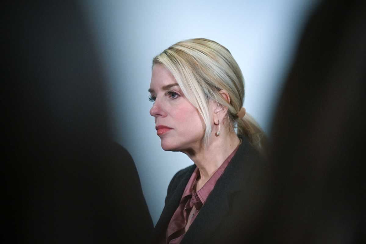 A side profile of Pam Bondi, a white woman with long blonde hair tied back in a ponytail.