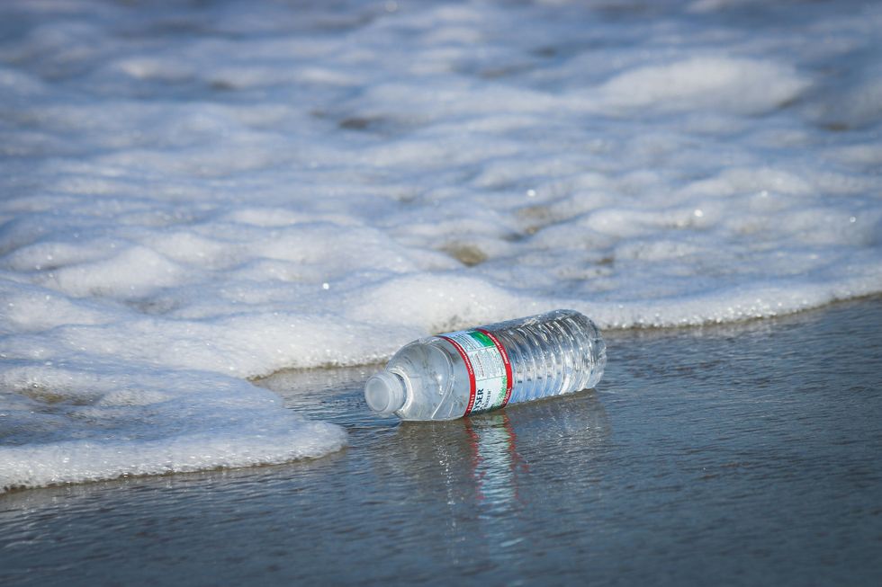 A single-use plastic bottle by the ocean