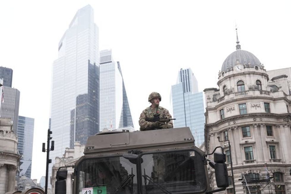 A soldiers sits on the top of a tank during the Lord Mayor\u2019s Show 2024