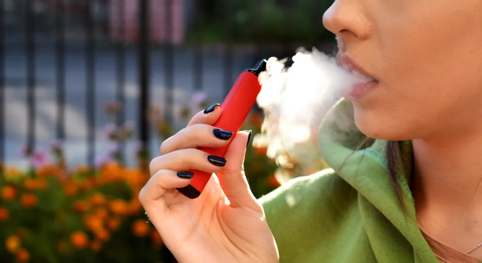 A stock image of a person vaping