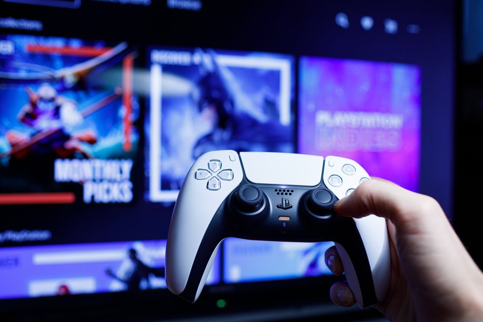 A stock image of a PS5 controller with the PS Store in the background