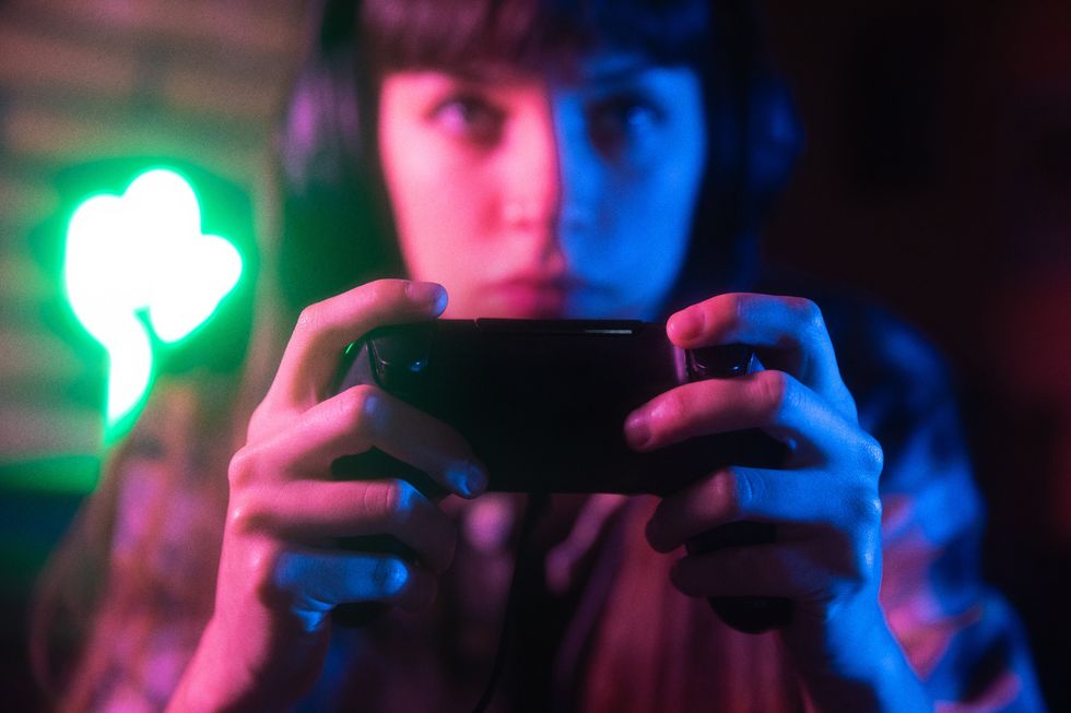 A stock image of a woman playing video games.