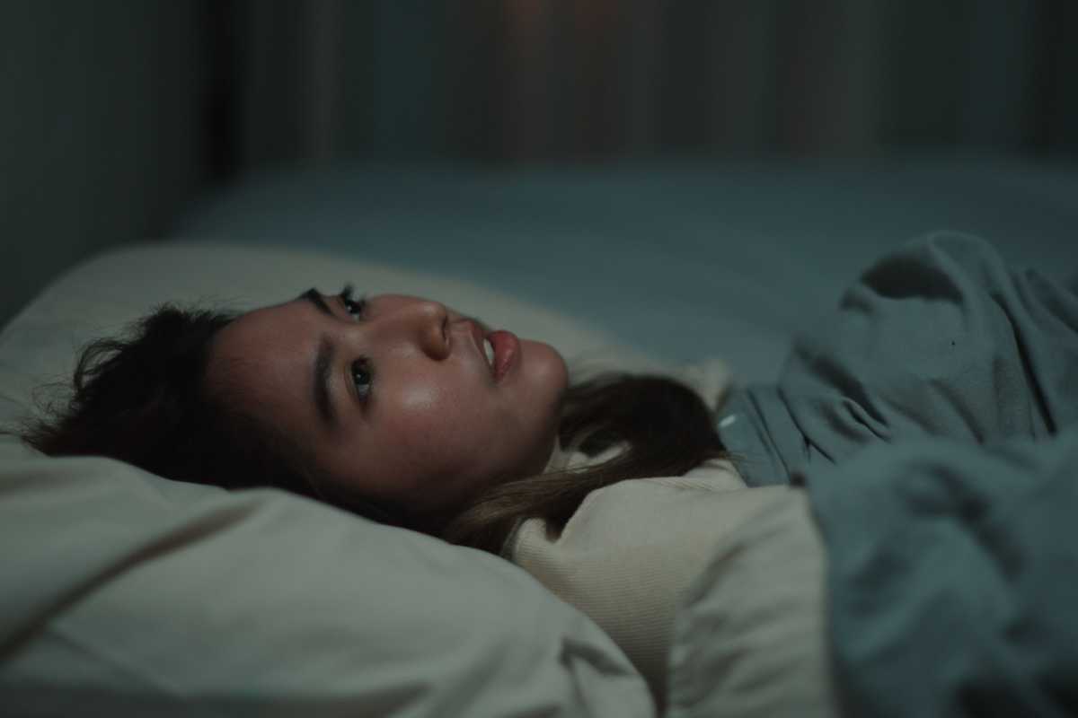 A stock image of a woman who cannot sleep at night