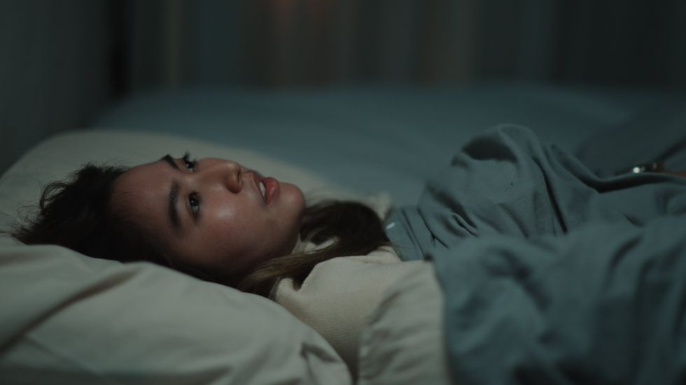 A stock image of a woman who cannot sleep at night