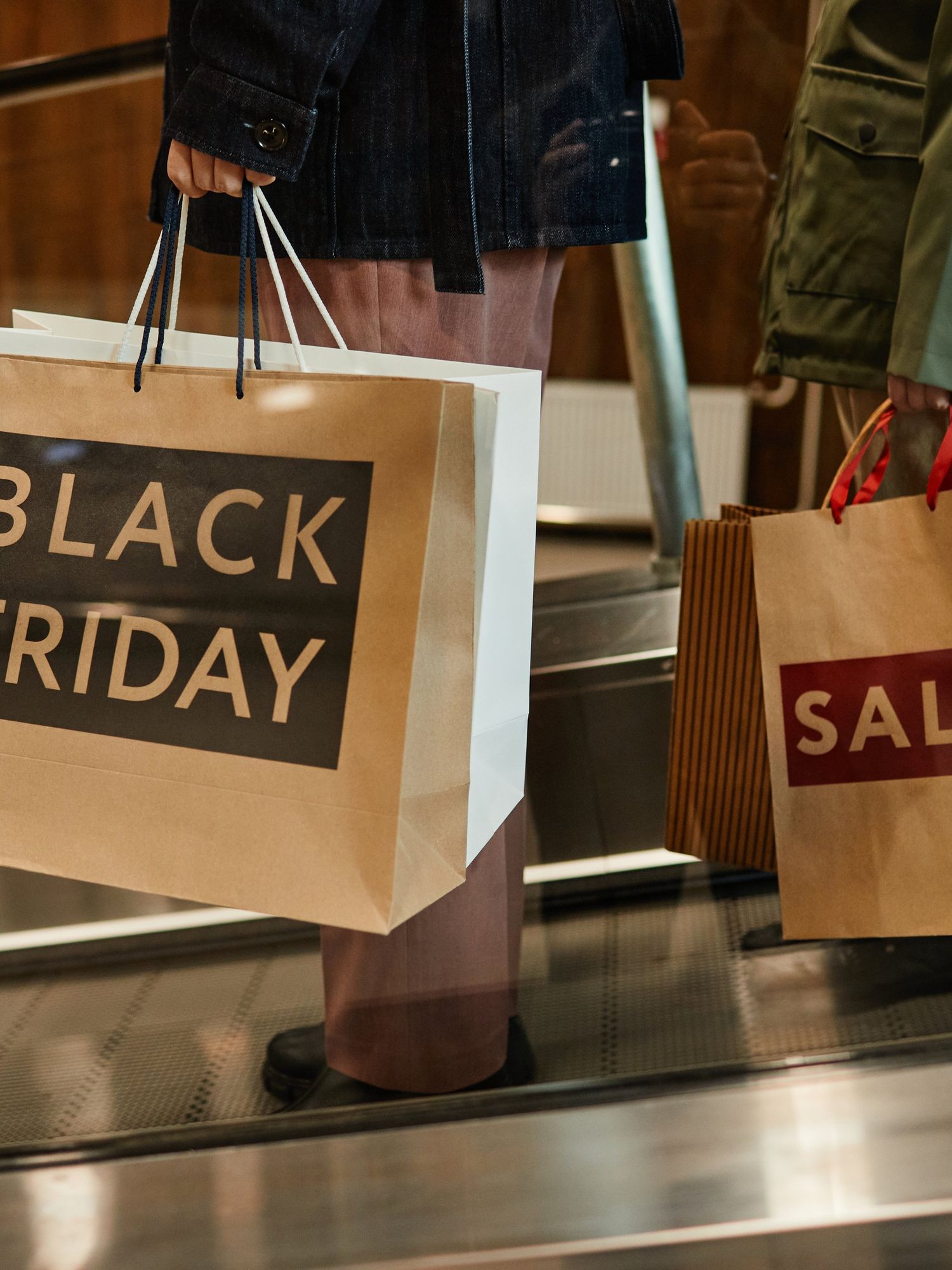 A stock image of people holding Black Friday shopping bags