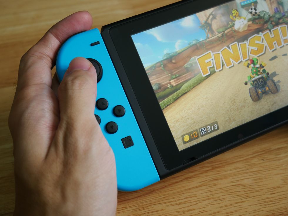 A stock image of someone playing Mario Kart on Nintendo Switch
