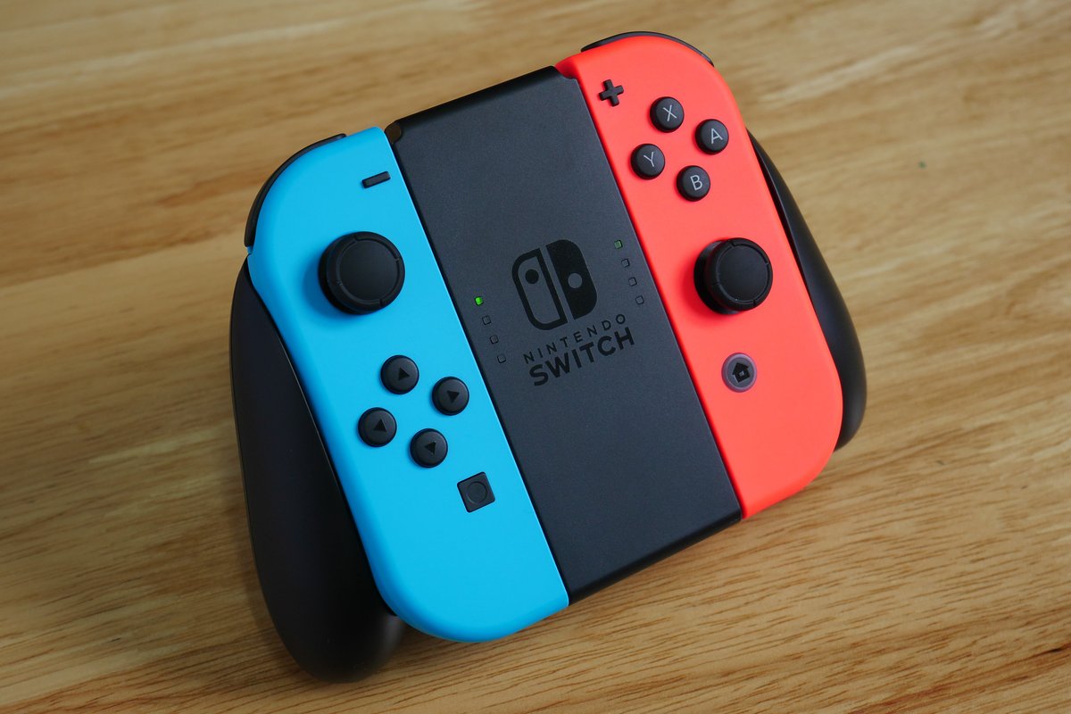 A stock photo of a Nintendo Switch controller on a wooden table