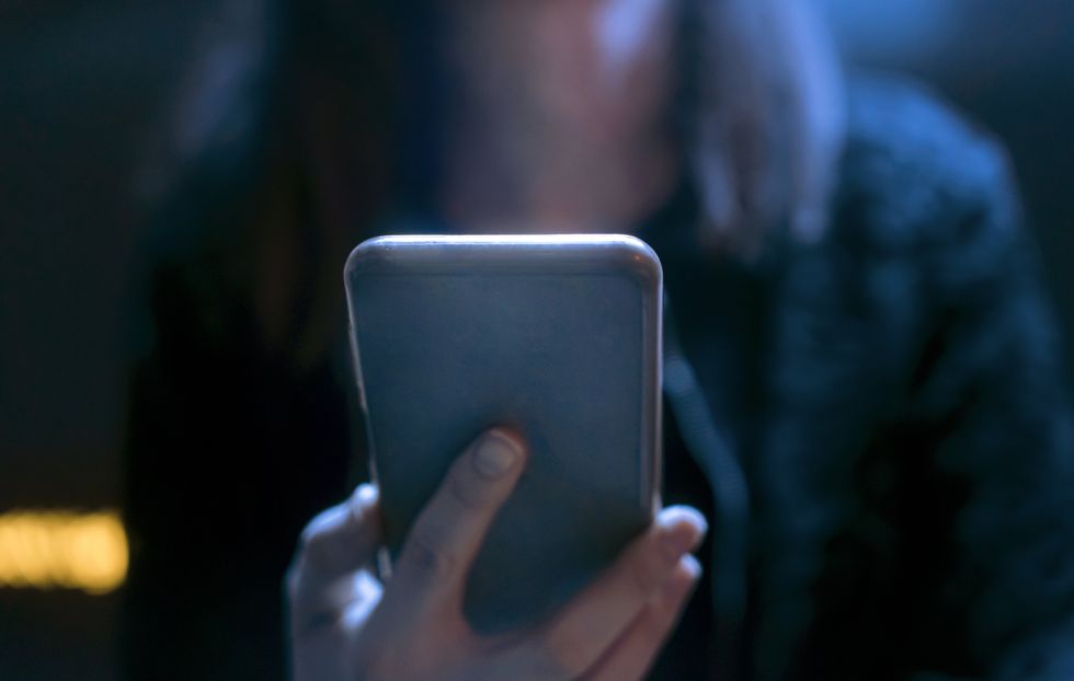 A stock photo of someone holding a smartphone