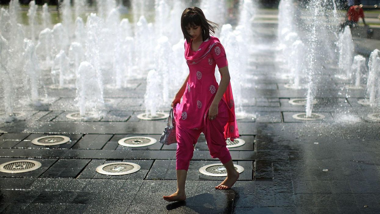 A student cools off in the fountains of Piccadilly Gardens in Manchester.  Picture: Christopher Furlong/Getty Images