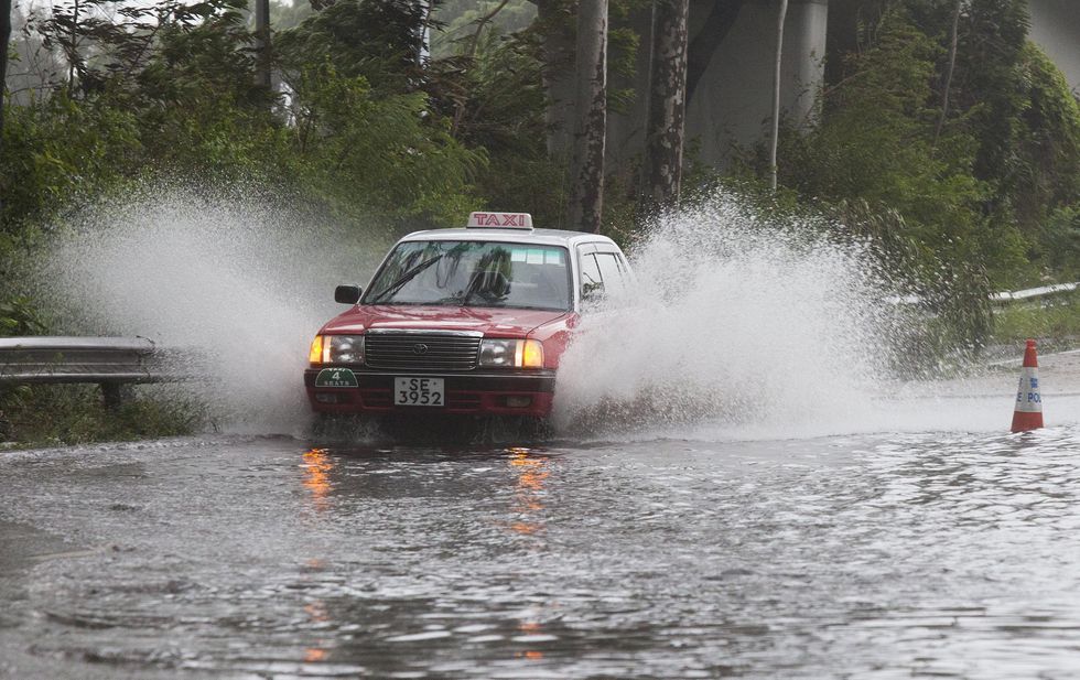 A taxi drives through a flooded section of Hong Kong's Eastern corridor highway during the passing of tropical storm Pakhar, Hong Kong, China, 27 August 2017. Picture: