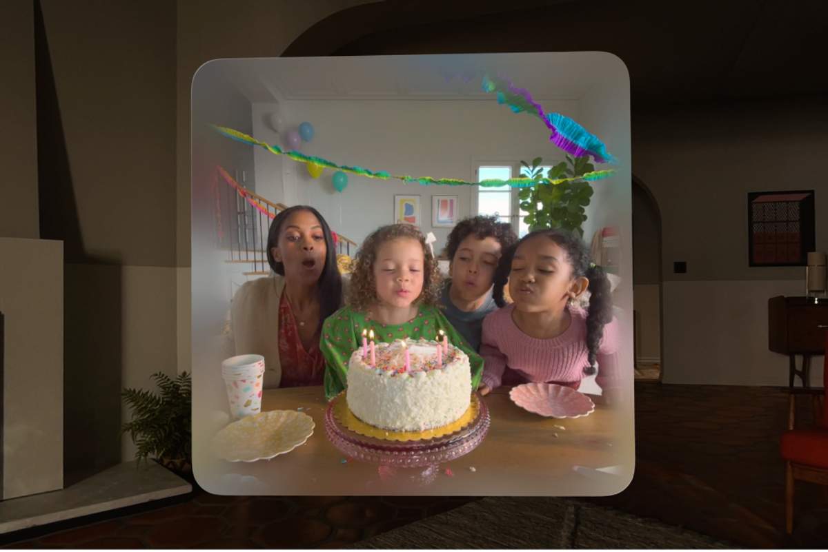 A video replay of three children enjoying a birthday party using the Apple Vision Pro. They are blowing out candles on a cake.
