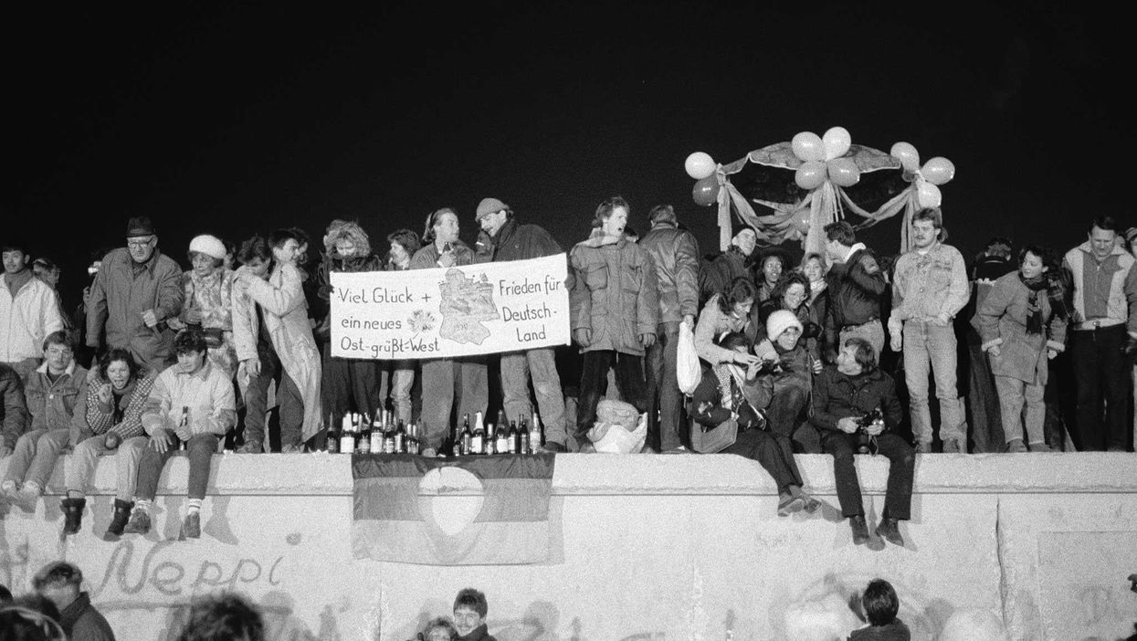 A view from the east of Berliners gathered on the Berlin Wall to celebrate the New Year and the effective end of the city's partition, 1989