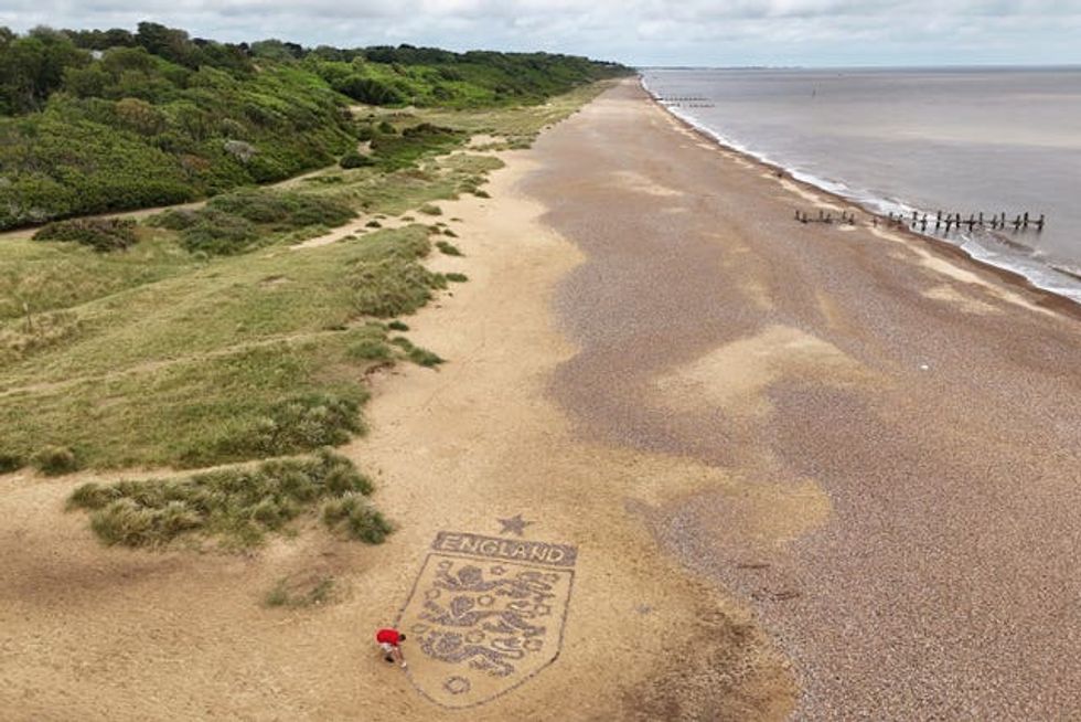 A view of a giant England badge made by artist Toby Clark using stones found on the beach near Lowestoft, Suffolk. (Joe Giddens/ PA)