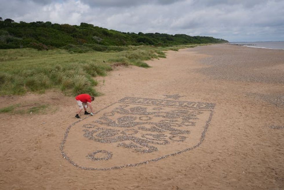 A view of a giant England badge made by artist Toby Clark using stones found on the beach near Lowestoft, Suffolk. (Joe Giddens/ PA)