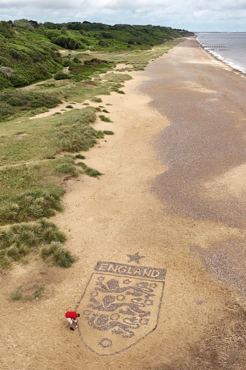 A view of a giant England badge made by artist Toby Clark using stones found on the beach near Lowestoft, Suffolk. (Joe Giddens/ PA)