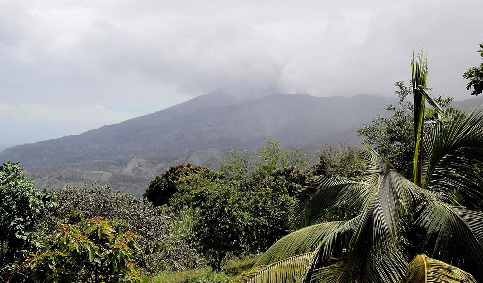 A view of the eruption of La Soufriere Volcano from Lennox Lampkin farm steaming in the distance at Rose Hall in Saint Vincent and the Grenadines on April 21, 2021