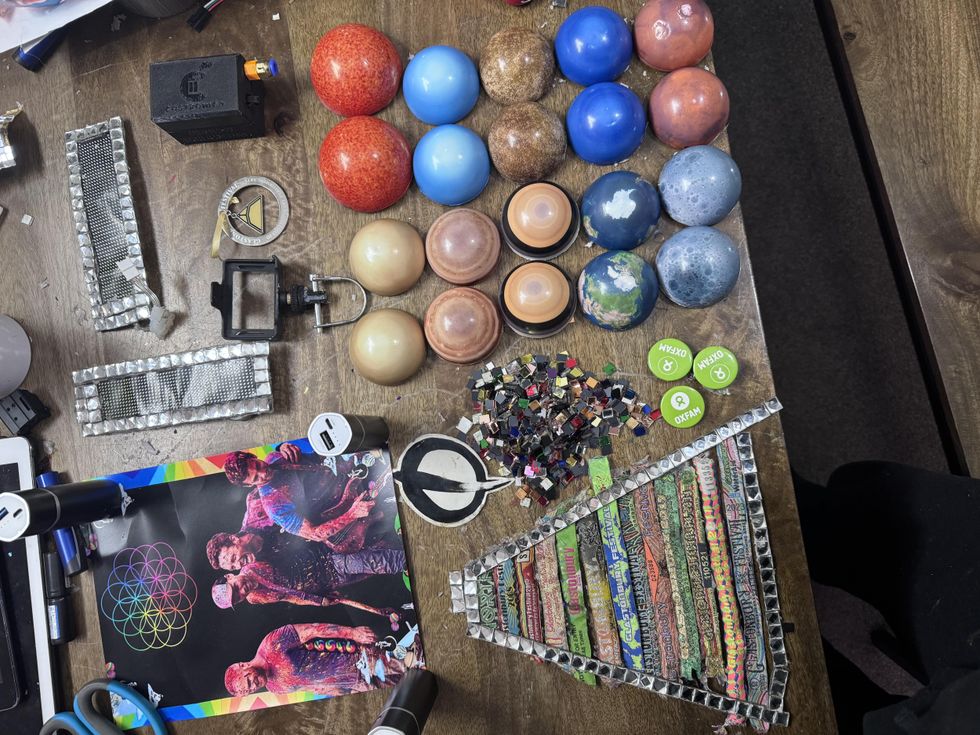 A view of the pieces of the hat, including a picture of Coldplay and Alex McGuire's wristbands from the festival in previous years