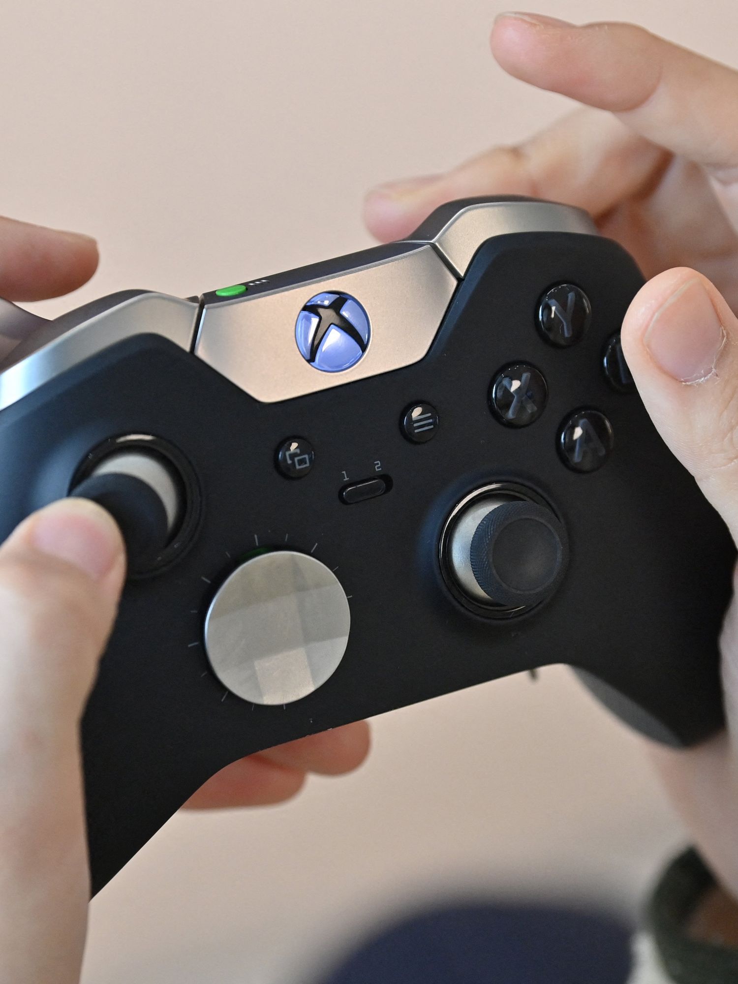 A visitor plays a game using Microsoft's Xbox controller at a flagship store of SK Telecom in Seoul on November 10, 2020