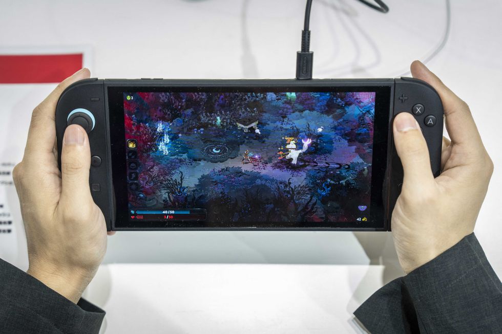 A vistor plays 'Hades 2' an upcoming independent game for Nintendo's Switch 2 during the BitSummit indie gaming expo in Kyoto city, Kyoto prefecture on July 18, 2025