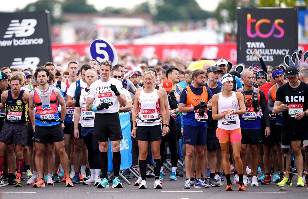 A wave of runners including James Cracknell and Sophie Raworth prepare to start the race (John Walton/PA)