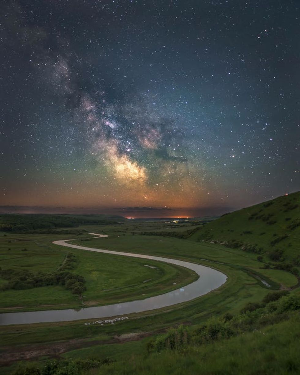 A winding road with the Milky Way stars above it