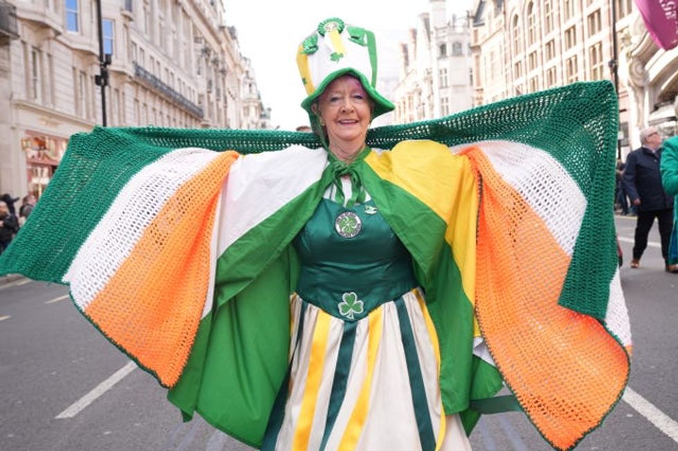 A woman dressed in orgen and green