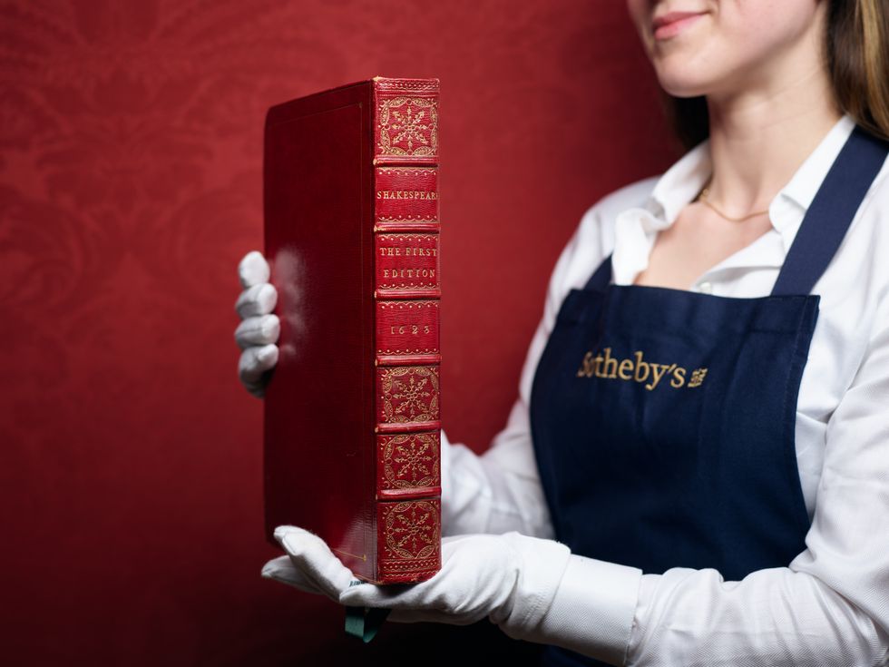 A woman from Sotheby's holding a Shakespeare folio