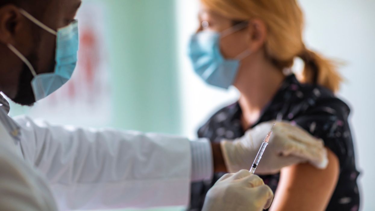 <p>A woman getting her coronavirus jab</p>