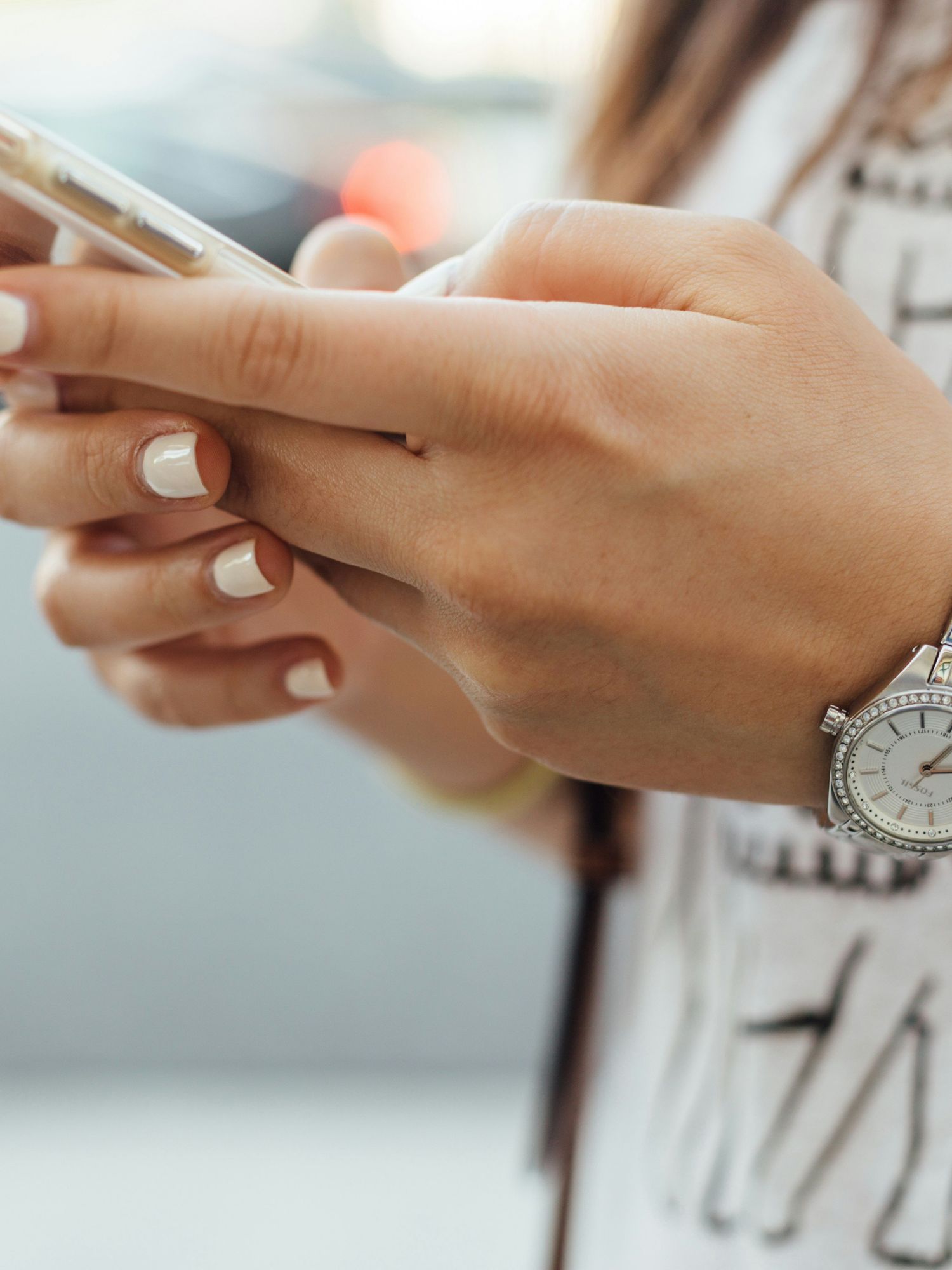 A woman holds a smartphone
