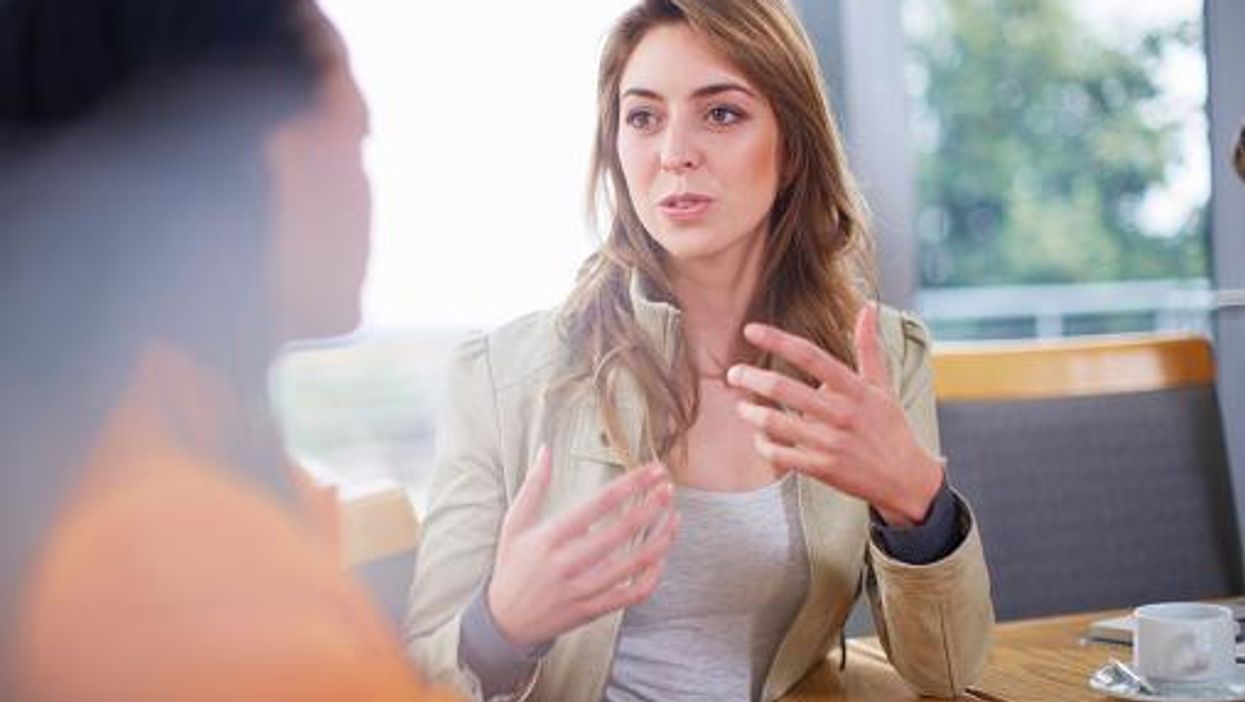 A woman in conversation with another