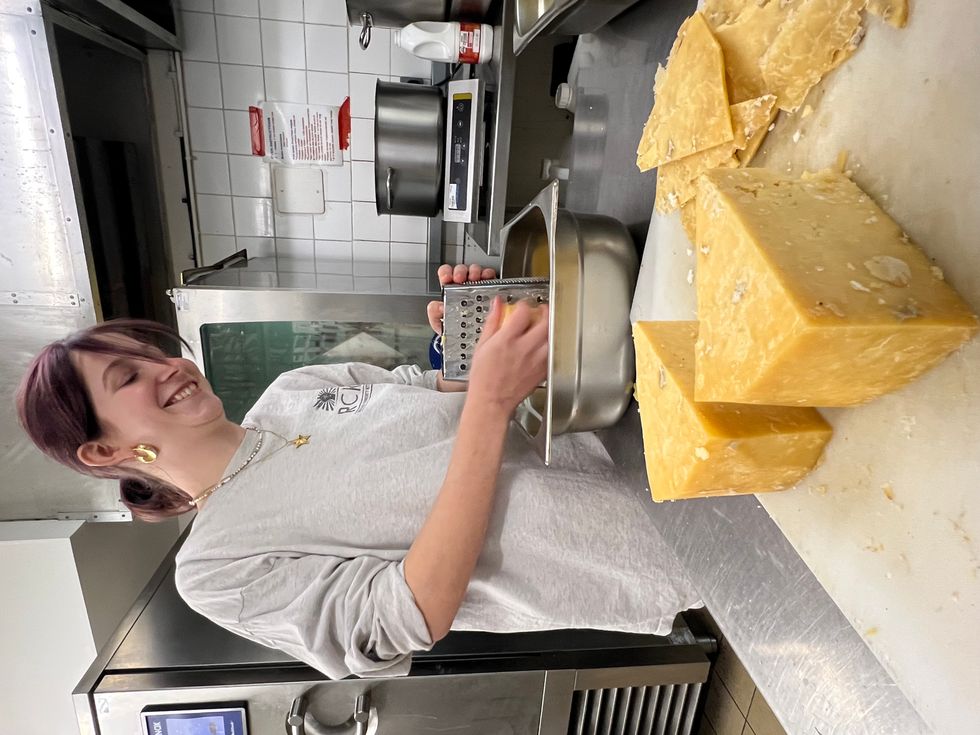 A woman preparing cheese