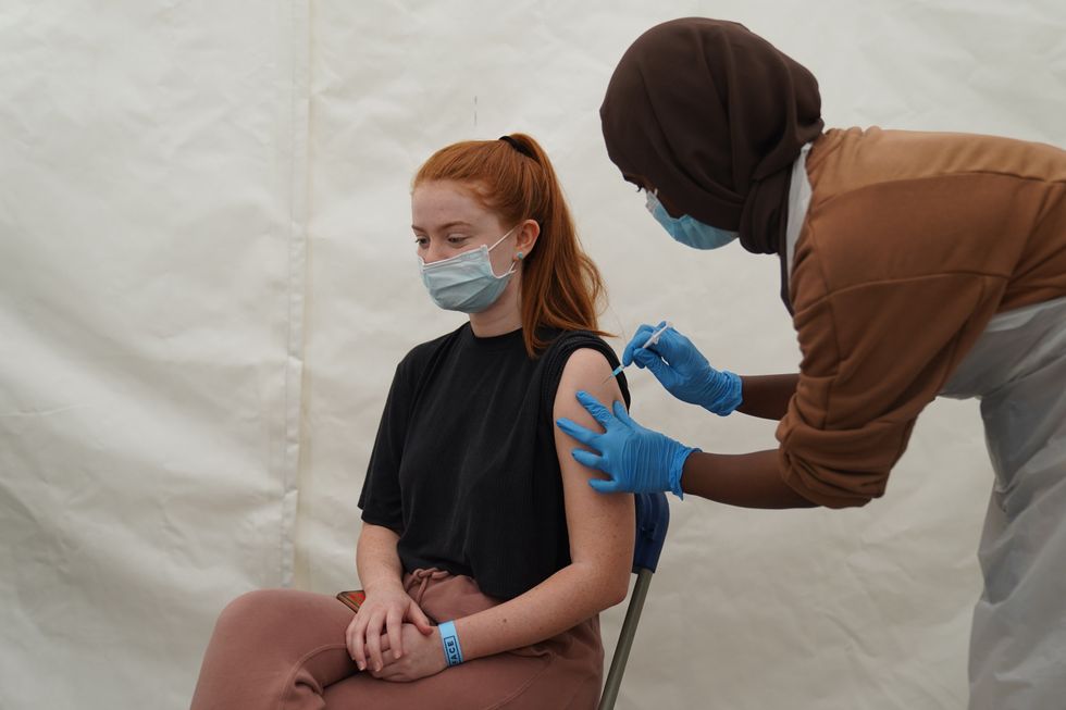 A woman receives a Covid-19 jab at a pop-up centre during the four-day vaccine festival in Langdon Park, Poplar, east London (Kirsty O\u2019Connor/PA)