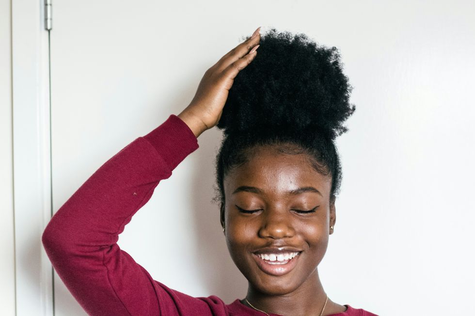A woman touches her hair