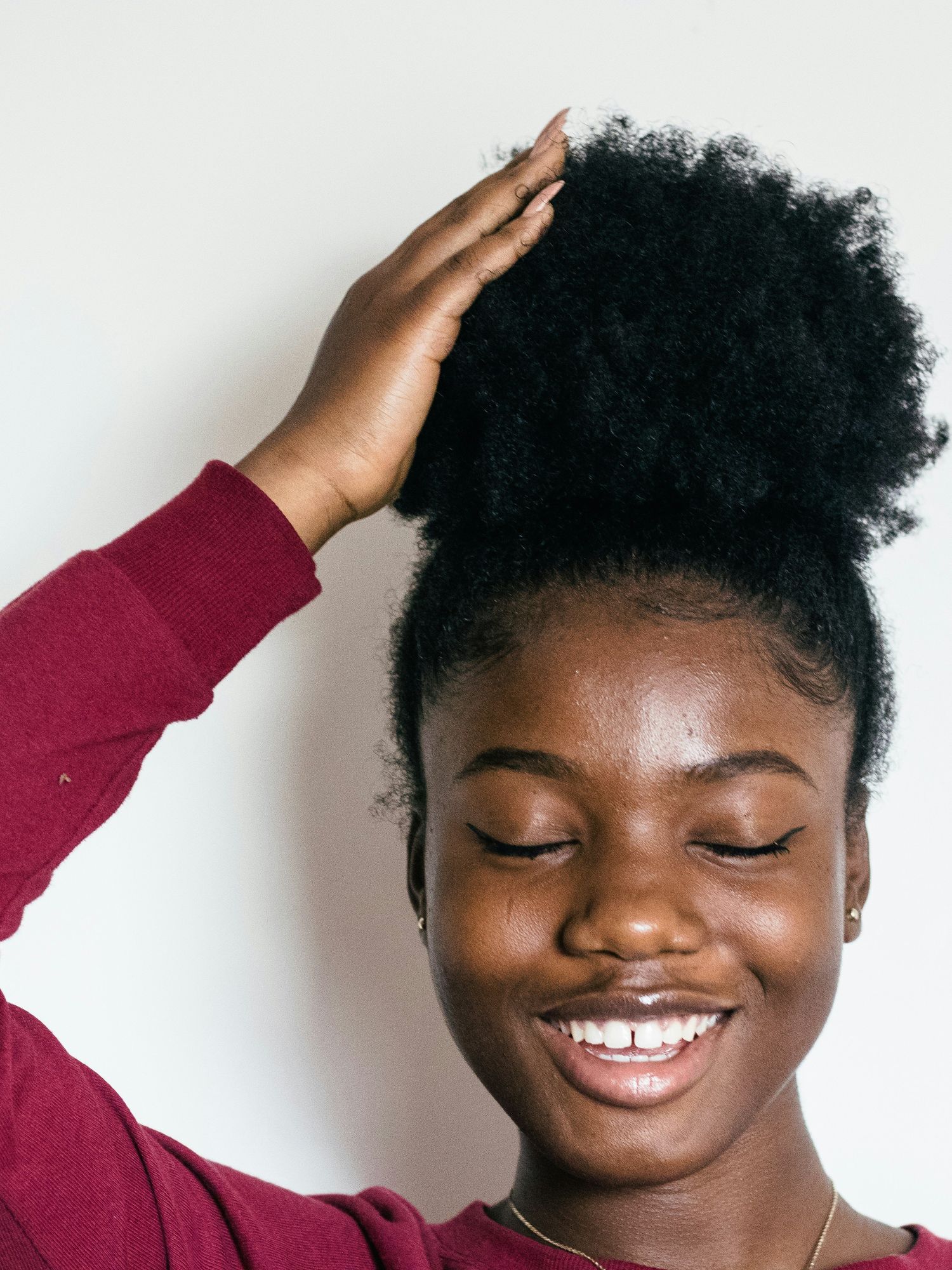 A woman touching her hair