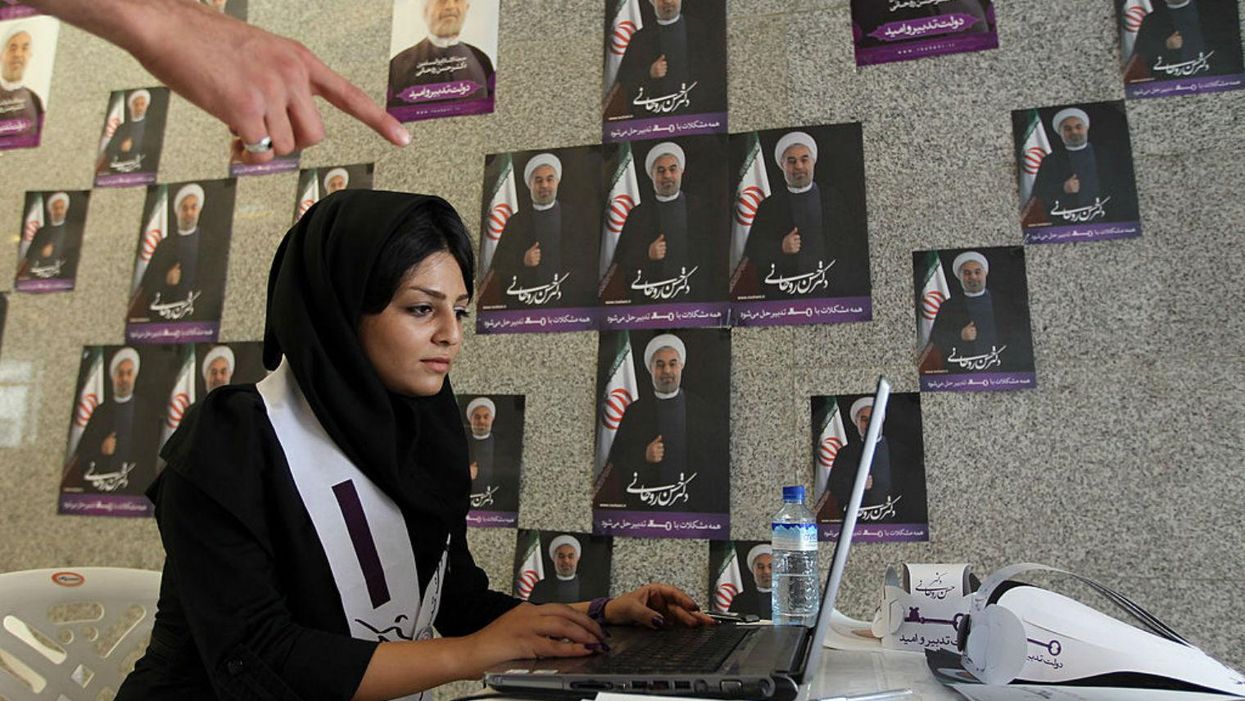 A woman works on her laptop in one of Hassan Rouhani’s campaign offices in Tehran