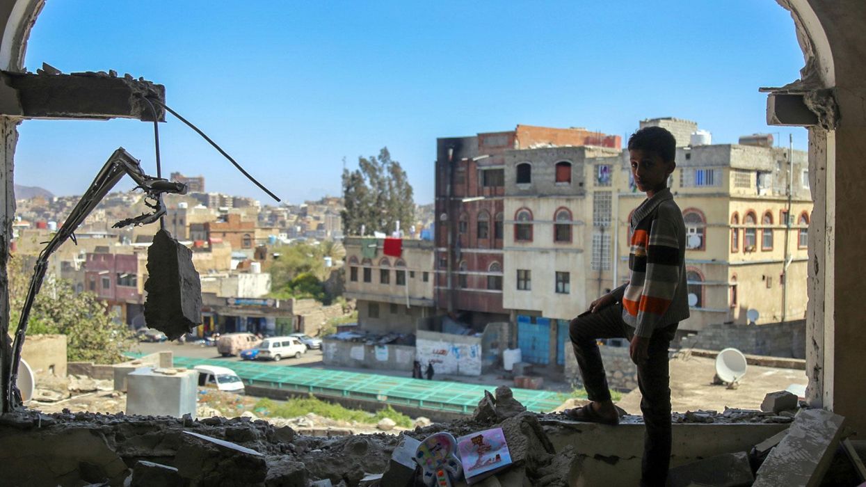 A Yemeni boy checks the damage following a mortar shell attack on the country's southern city of Taez