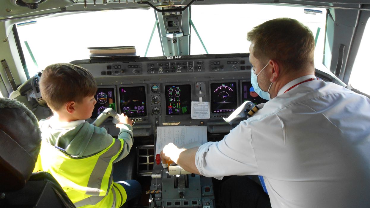 A young boy in an aircraft's cockpit