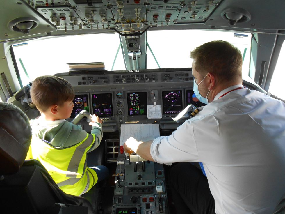 A young boy in an aircraft's cockpit
