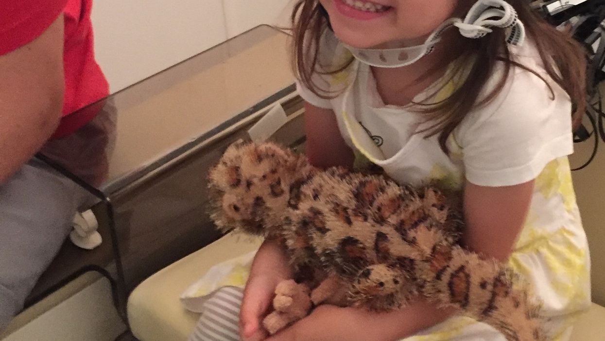 A young girl wearing the the world’s first wearable MEG (magnetoencephalography) brain scanning system (Handout/PA)