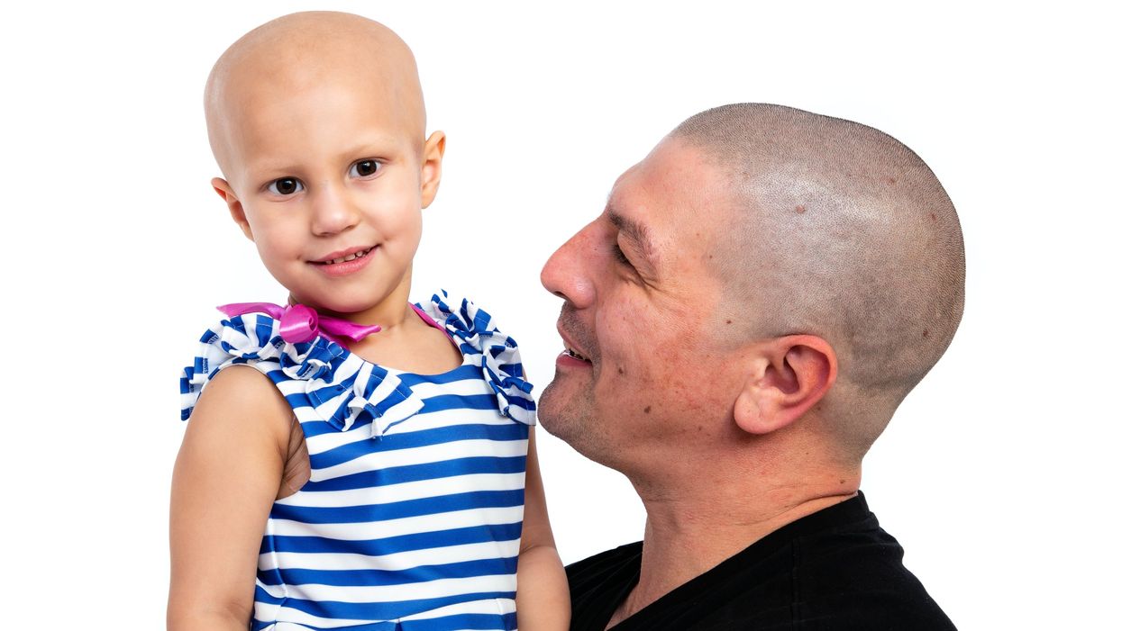 Aaron Lambert, 36, with his daughter Esme Lambert. Mr Lambert got a tattoo of his daughter's brain surgery scar so she does not feel like the 'odd one out'. (Wendy Lambert/ PA)