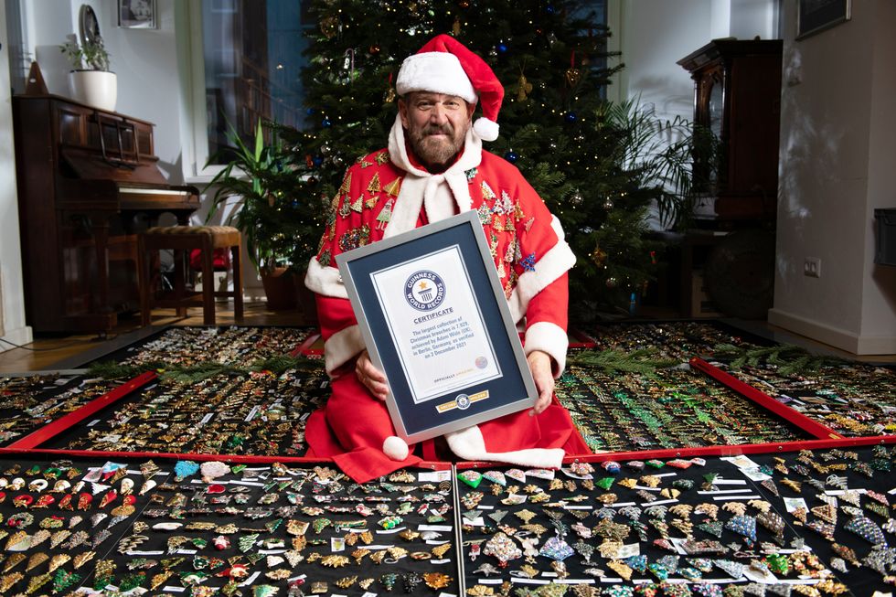 Adam Wide achieved the Guinness World Records title for the largest collection of almost 7,929 Christmas brooches. (Smallfish Productions/Guinness World Records)