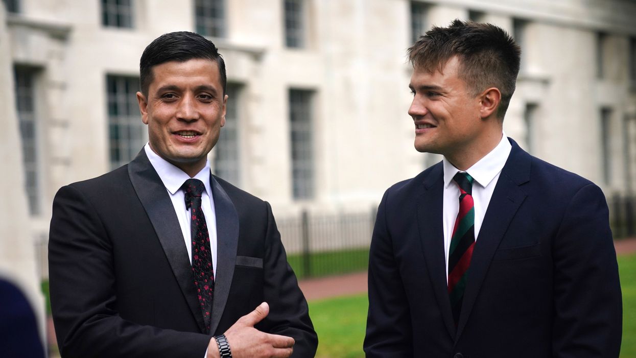 Afghan special operations officer First Lieutenant Mohammad Jawad Akbari, left, and British Army officer Captain Dave Kellett talk to each other by the Iraq Afghanistan Memorial at the Ministry of Defence building in Westminster, central London (Victoria Jones/PA)