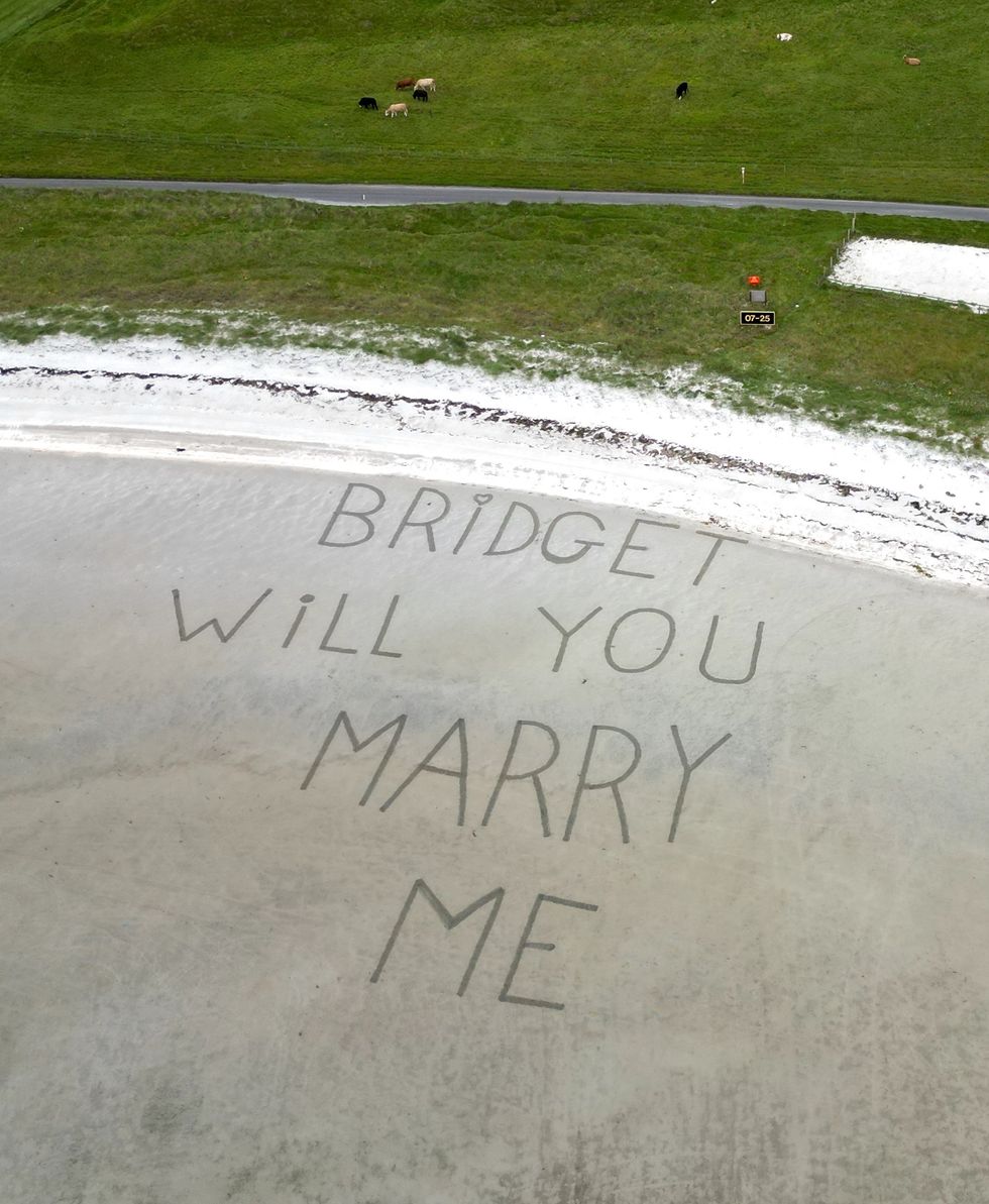 Marriage proposal etched into runway sand for man’s sky-high proposal