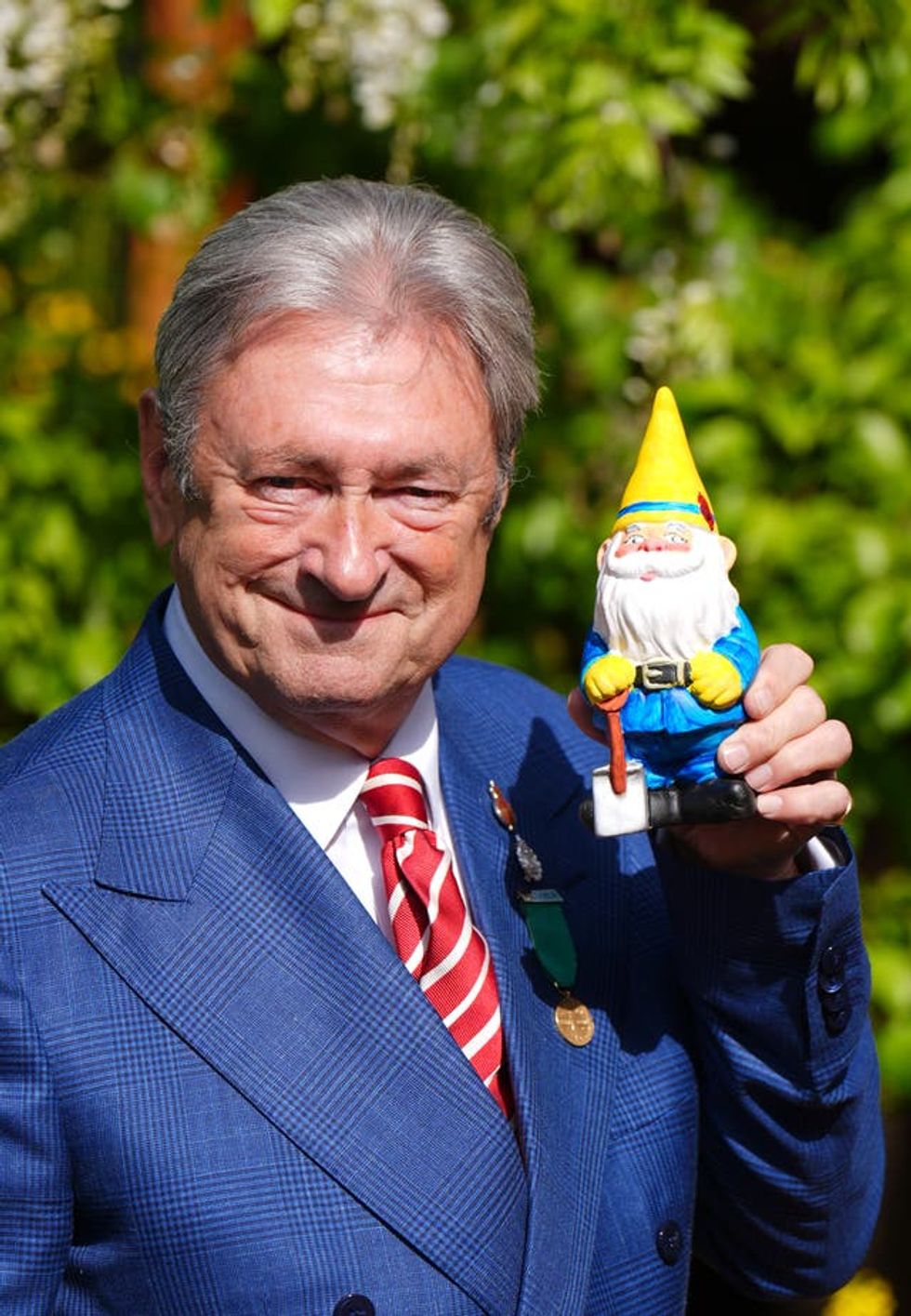 Alan Titchmarsh holding the gnome has painted to raise money for the RHS Campaign for School Gardening, at the RHS and The King\u2019s Foundation Curious Garden exhibit, during press day at the RHS Chelsea Flower Show, at the Royal Hospital Chelsea in London