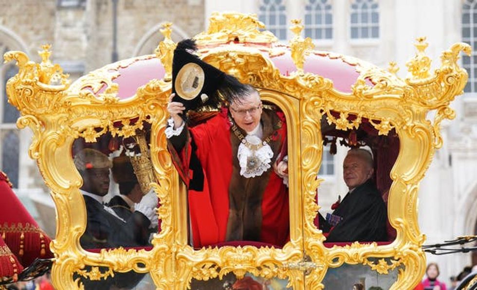 Alastair King, the 696th Lord Mayor of the City of London, waves from the state coach during the Lord Mayor\u2019s Show in the City of London