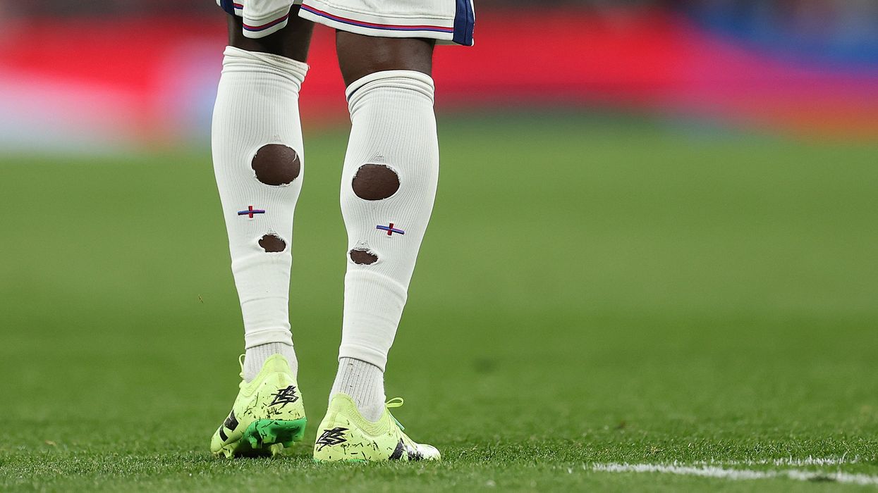 Why do footballers cut holes in their socks?