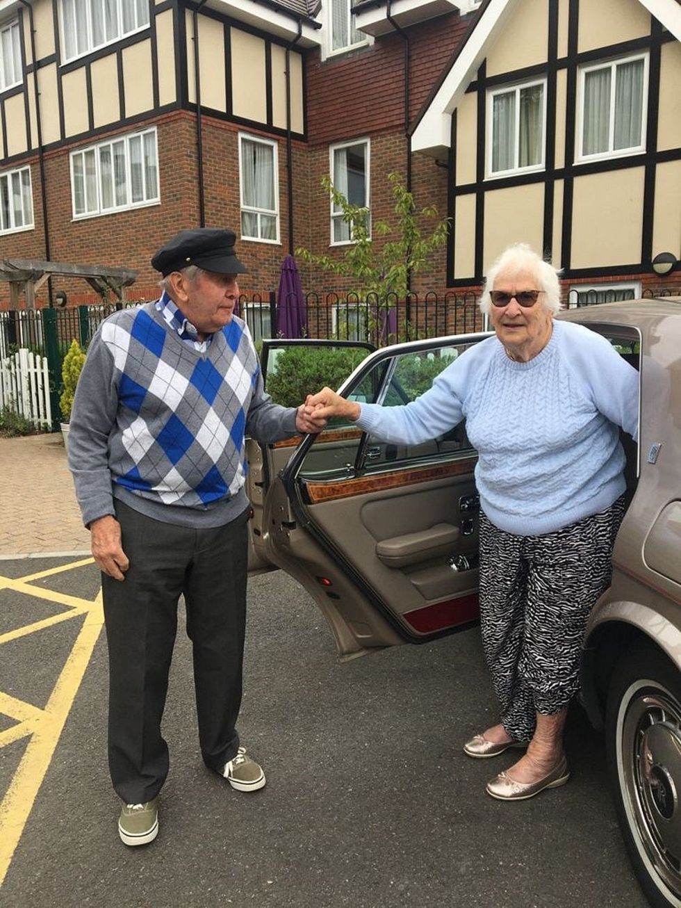 Alec Goy helping fellow resident Eve out of the Rolls Royce (Care UK\u2019s Weald Heights/PA).