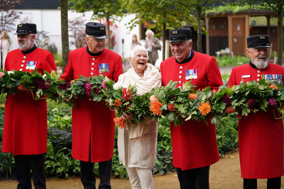 All smiles as Dame Judi poses with Chelsea Pensioners (Yui Mok/PA)