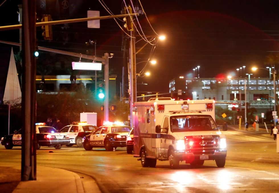An ambulance leaves the concert venue after a mass shooting at a music festival on the Las Vegas Strip