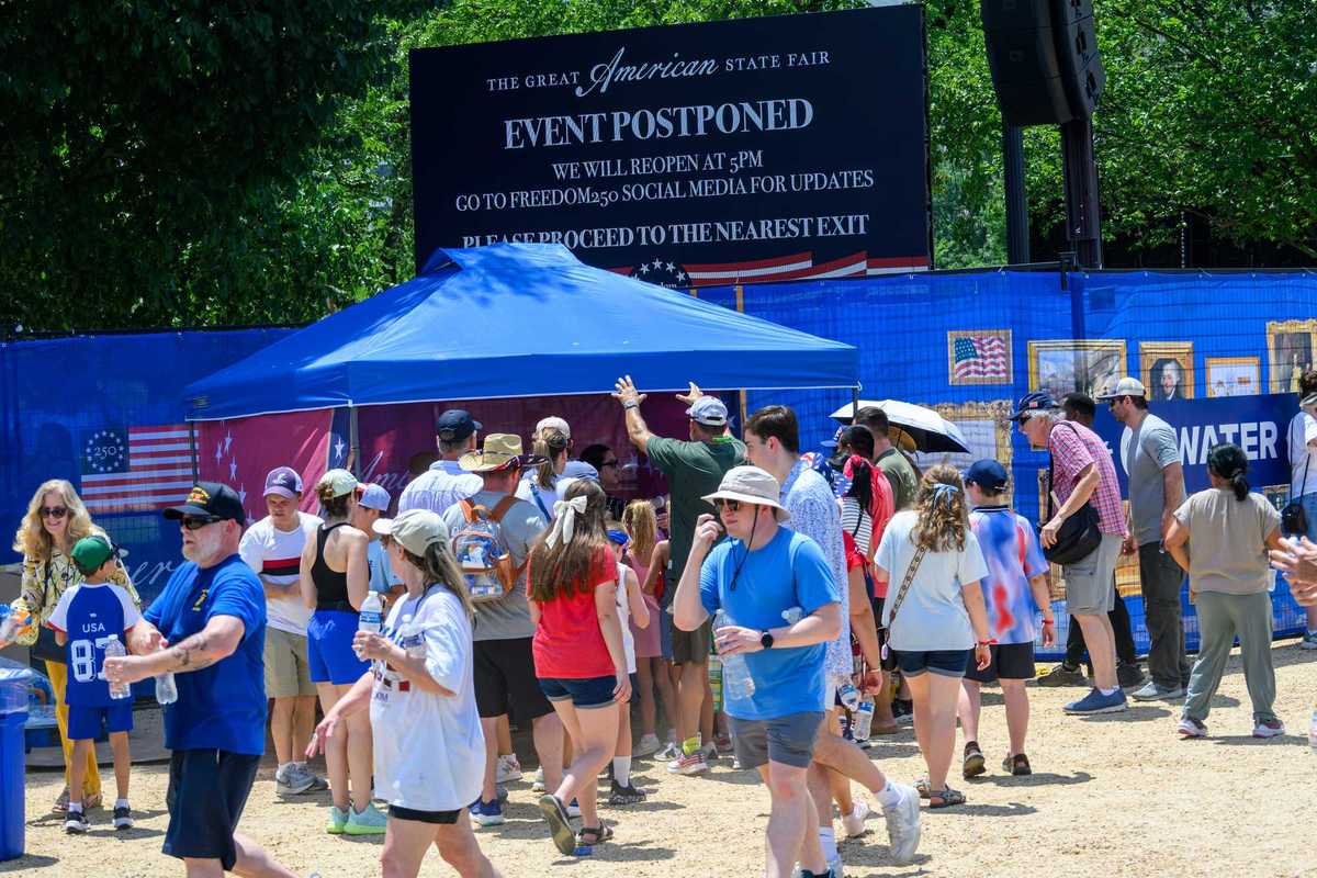 An "event postponed" sign is displayed above a water tent at the Great American State Fair.